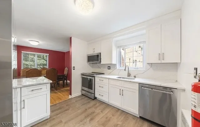 a kitchen with a sink stove and cabinets