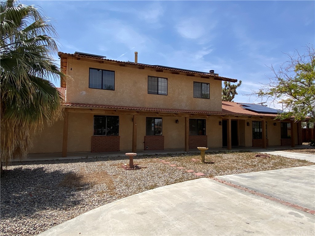 20157 Ituma Road Apple Valley, CA 92308 - Photo 1 of 1 a front view of a house with a yard