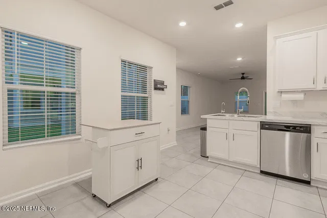 a kitchen with white cabinets and white appliances
