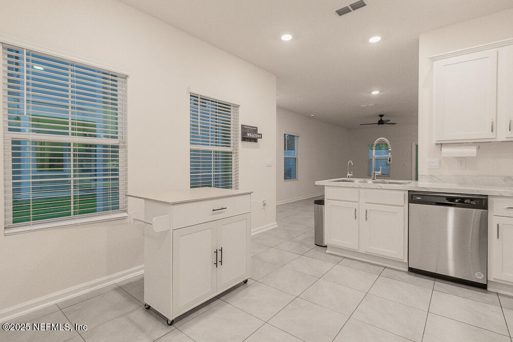 957 Observatory Parkway Jacksonville, FL 32218 - Photo 13 of 27 a kitchen with white cabinets and white appliances