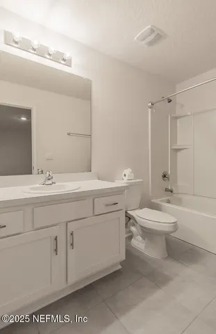 a bathroom with a toilet a sink a mirror and a bathtub