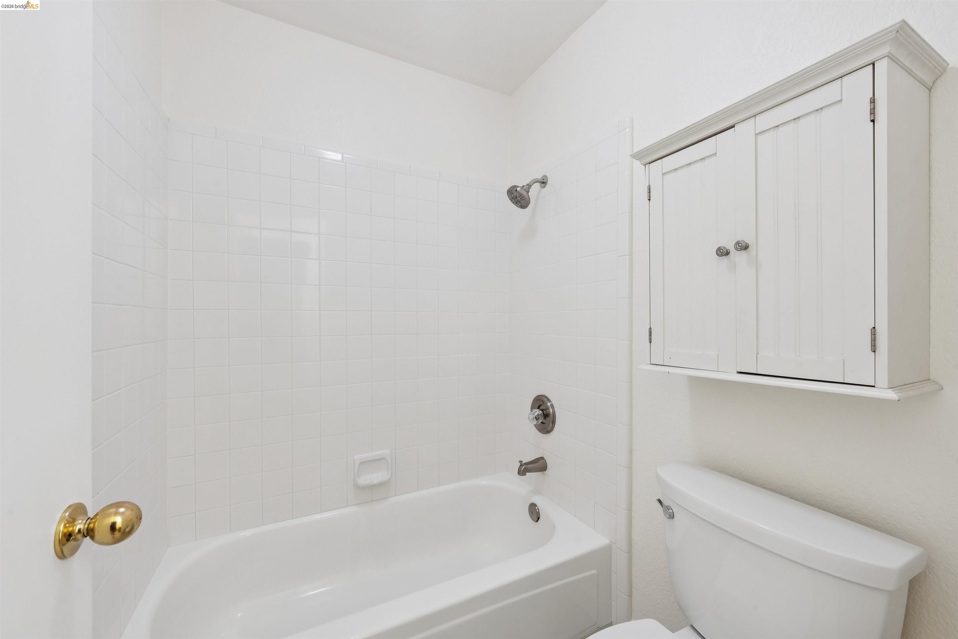 261 Redhawk Road Novato, CA 94949 - Photo 36 of 44 Bathtub with white subway tile surround and brushed nickel fixtures