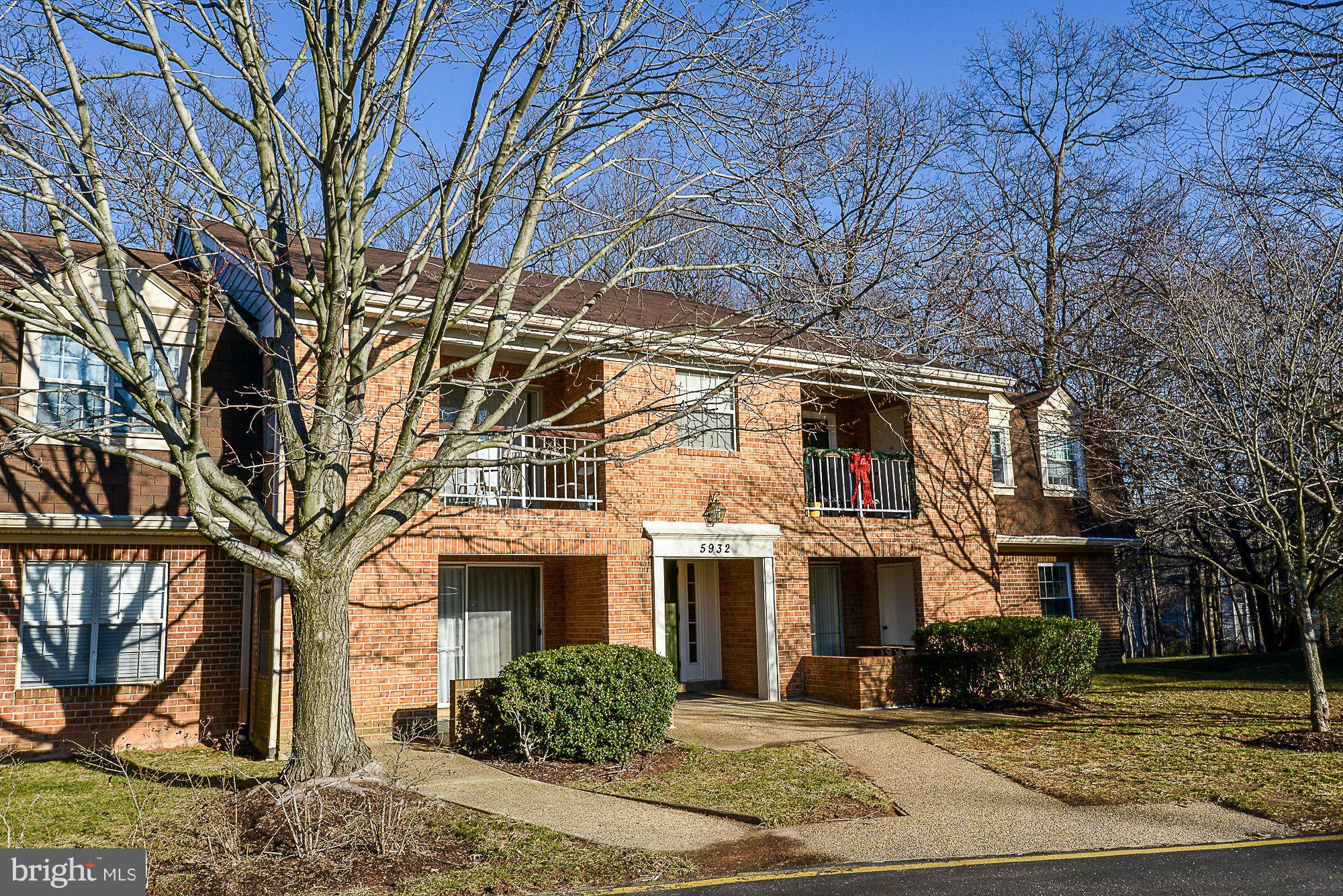 5932 Cove Landing Road, Unit 201D Burke, VA 22015 - Photo 1 of 24 a front view of residential houses with yard and trees