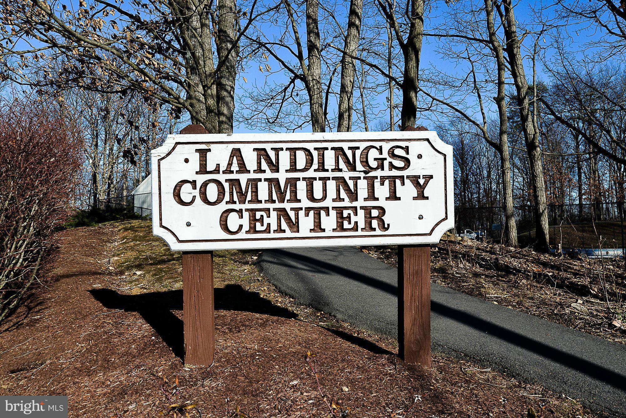 5932 Cove Landing Road, Unit 201D Burke, VA 22015 - Photo 22 of 24 a view of a street sign under a large tree