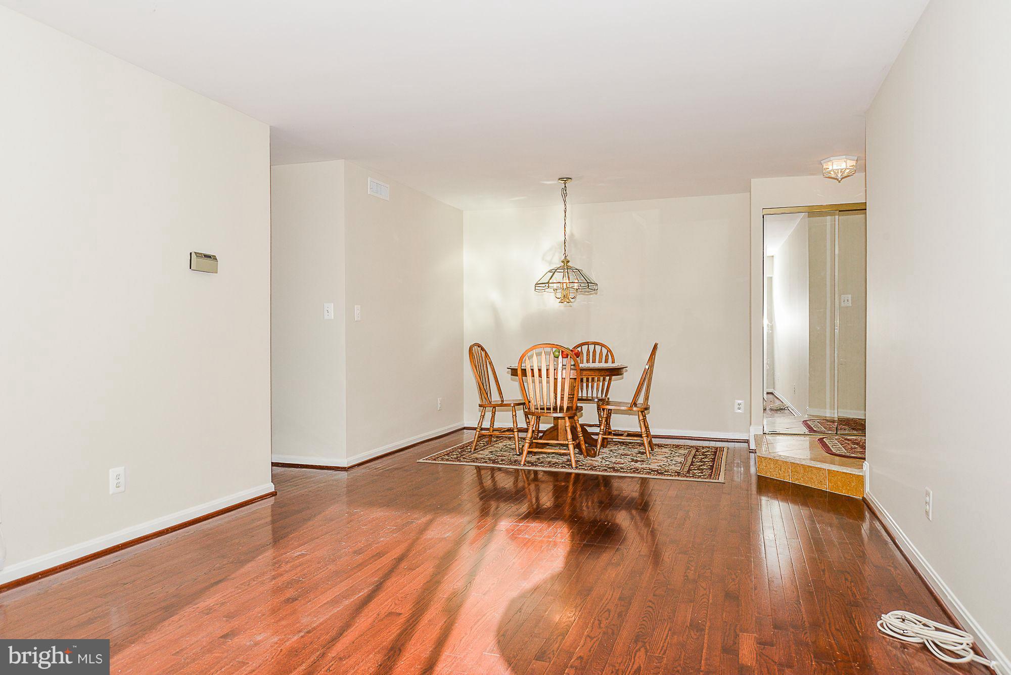 5932 Cove Landing Road, Unit 201D Burke, VA 22015 - Photo 5 of 24 a view of a room with furniture and wooden floor