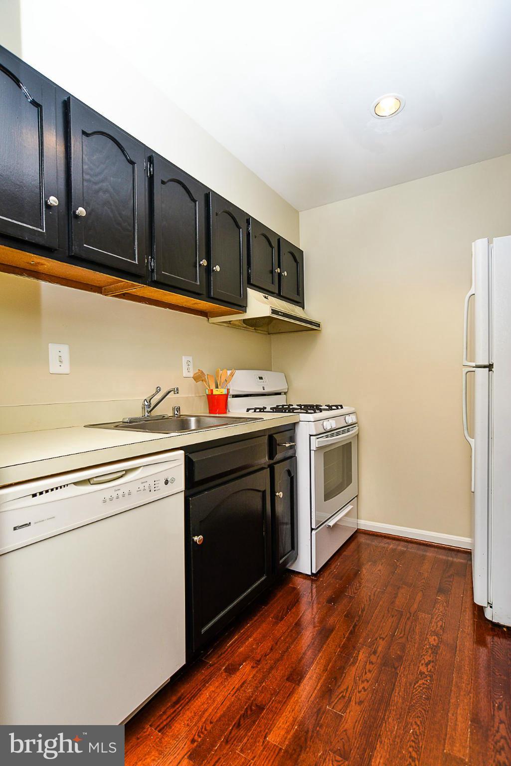5932 Cove Landing Road, Unit 201D Burke, VA 22015 - Photo 8 of 24 a kitchen with stainless steel appliances granite countertop a stove and a refrigerator
