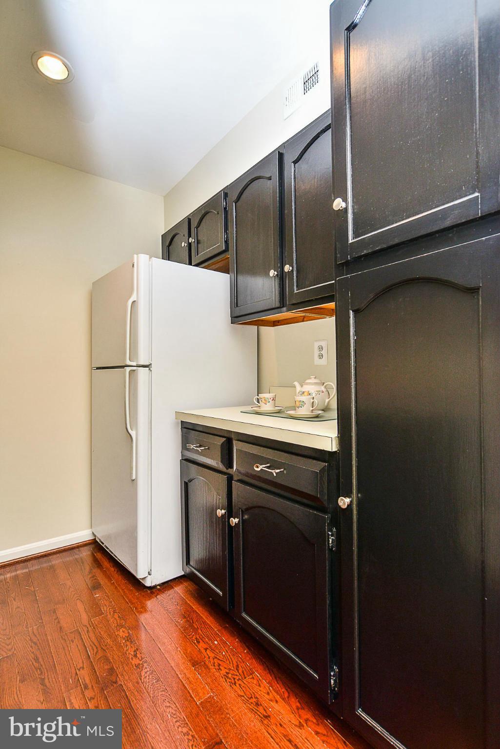5932 Cove Landing Road, Unit 201D Burke, VA 22015 - Photo 9 of 24 a kitchen with a refrigerator and cabinets