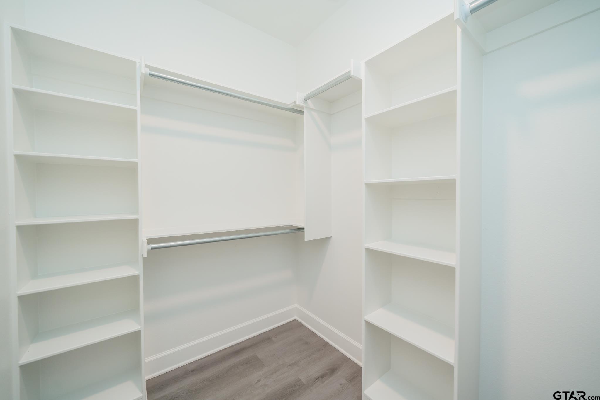 390 Alexander Street Kilgore, TX 75662 - Photo 17 of 34 a view of walk in closet with empty racks