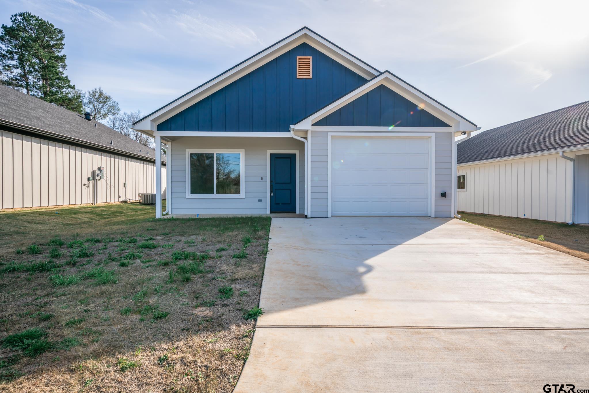 390 Alexander Street Kilgore, TX 75662 - Photo 2 of 34 a front view of a house with a yard and garage