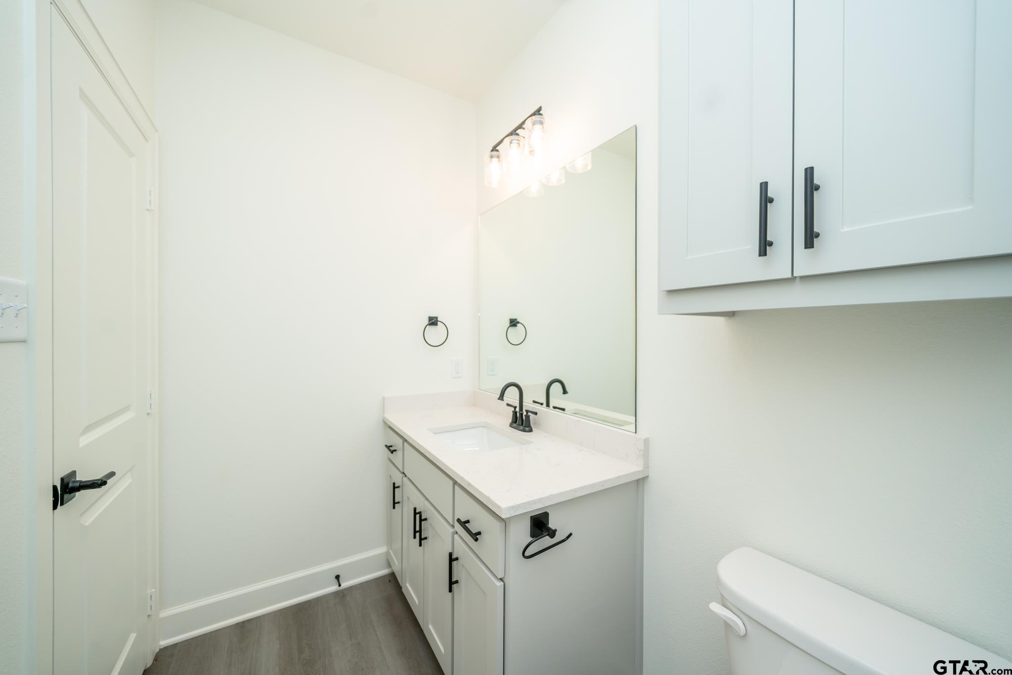 390 Alexander Street Kilgore, TX 75662 - Photo 27 of 34 a bathroom with a sink and a toilet