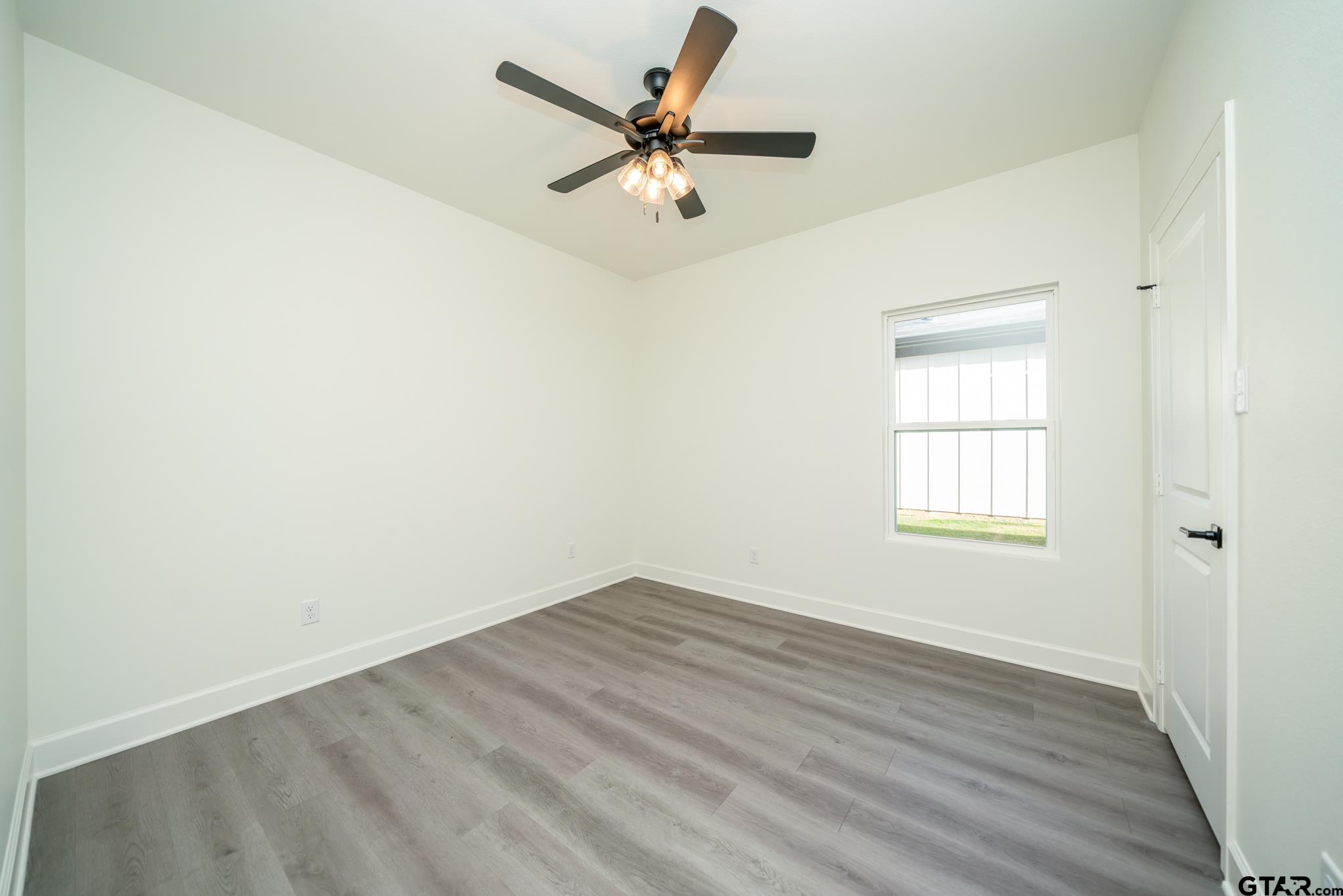 390 Alexander Street Kilgore, TX 75662 - Photo 29 of 34 an empty room with a window and a fan