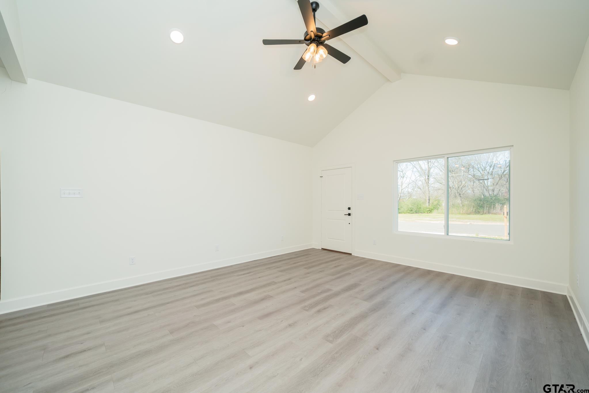 390 Alexander Street Kilgore, TX 75662 - Photo 7 of 34 wooden floor in an empty room with a window