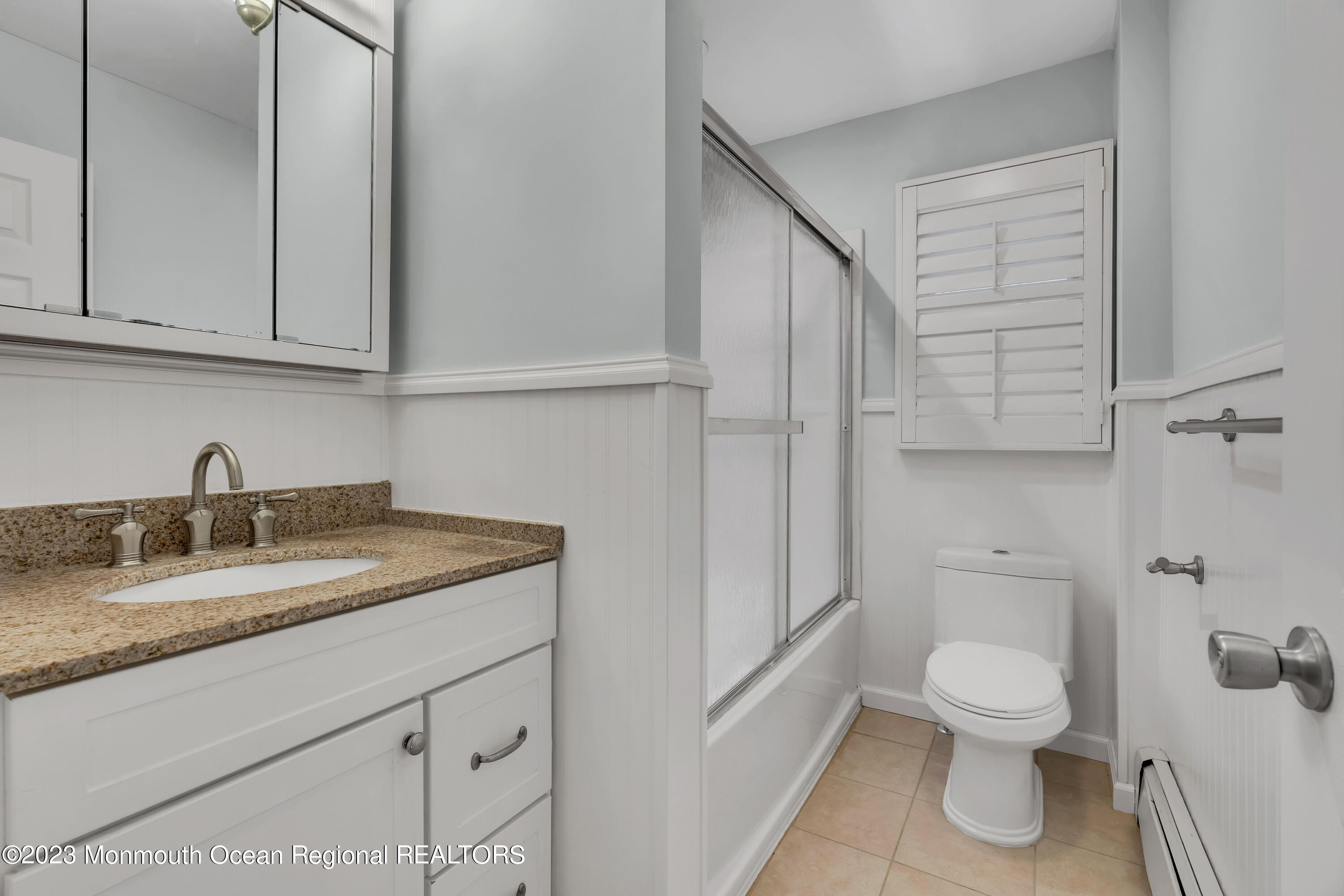 1007 Beaver Dam Road Point Pleasant, NJ 08742 - Photo 36 of 45 a bathroom with a granite countertop toilet a sink and a mirror