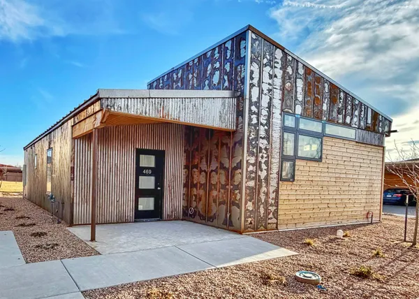 a view of a house with wooden fence