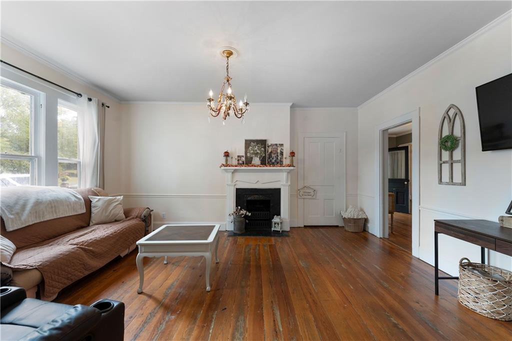 712 College Street Calhoun, GA 30701 - Photo 12 of 31 a living room with furniture and a fireplace