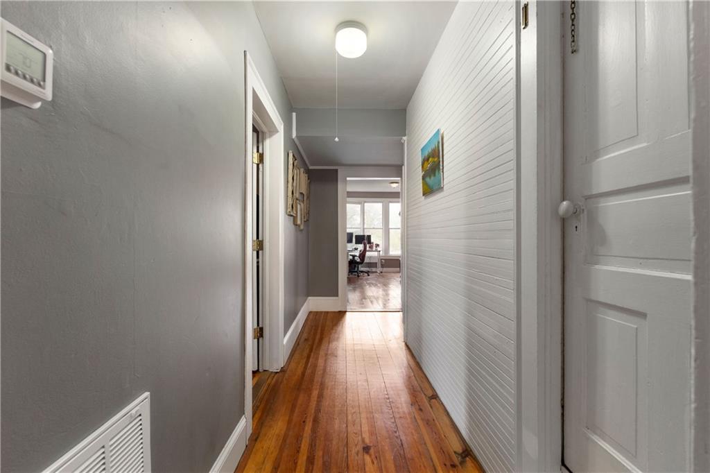 712 College Street Calhoun, GA 30701 - Photo 14 of 31 a view of a hallway with wooden floor and staircase