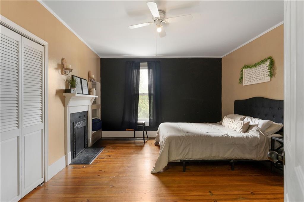 712 College Street Calhoun, GA 30701 - Photo 15 of 31 a bedroom with a bed and a chandelier