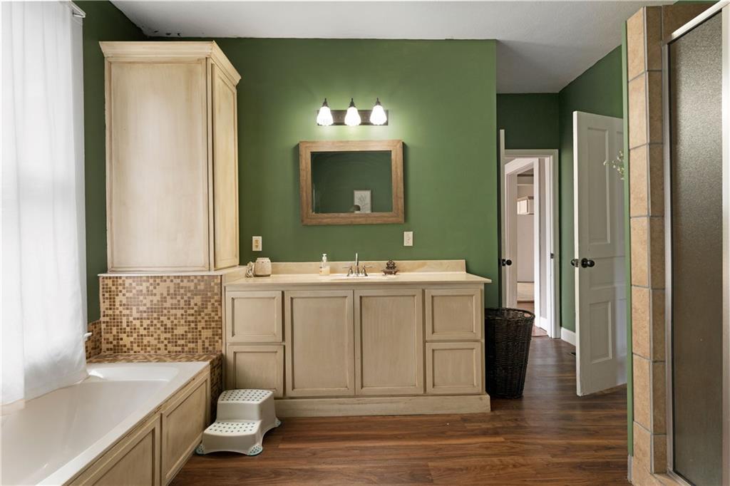 712 College Street Calhoun, GA 30701 - Photo 16 of 31 a bathroom with a sink and a large mirror