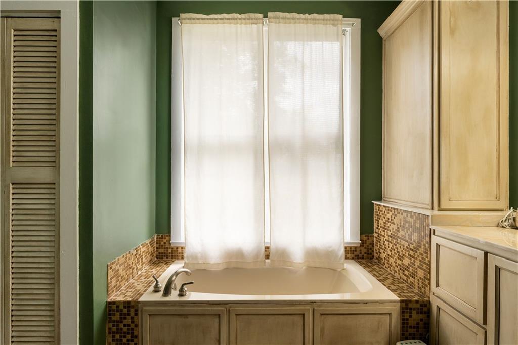 712 College Street Calhoun, GA 30701 - Photo 17 of 31 a bathroom with a granite countertop sink and a mirror