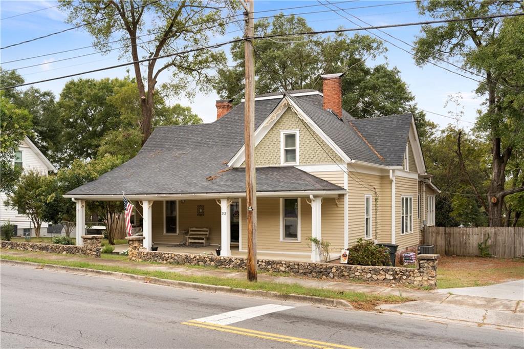 712 College Street Calhoun, GA 30701 - Photo 2 of 31 a front view of a house with a garden and tree