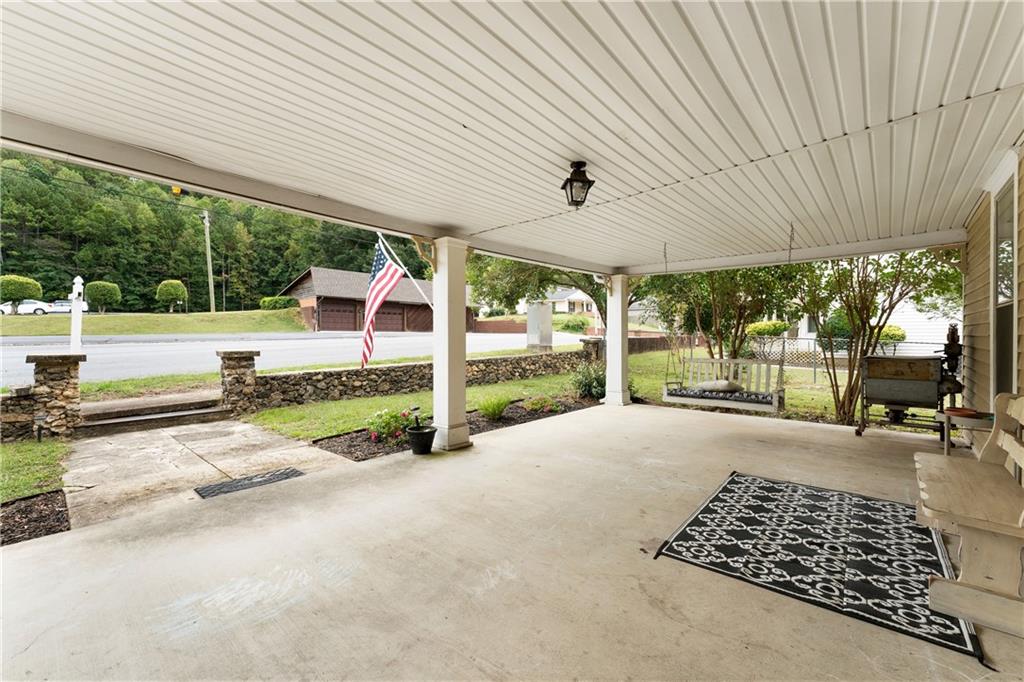 712 College Street Calhoun, GA 30701 - Photo 27 of 31 a view of a patio with table and chairs and wooden fence
