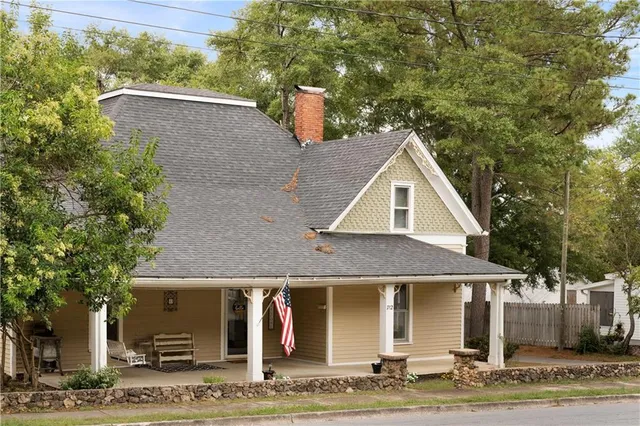 a front view of a house with garden