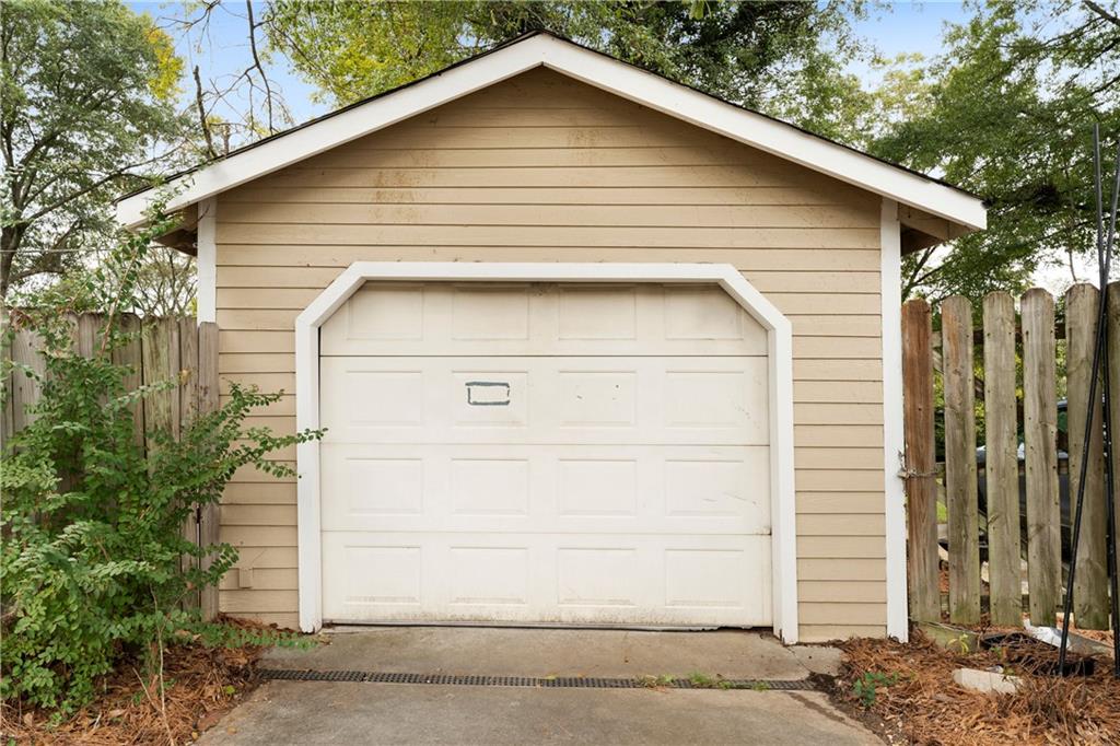 712 College Street Calhoun, GA 30701 - Photo 31 of 31 a white house with a small yard plants and large tree