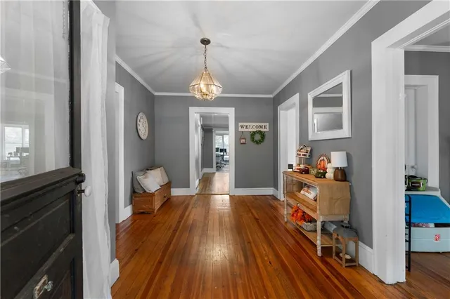 a view of a livingroom with wooden floor and furniture