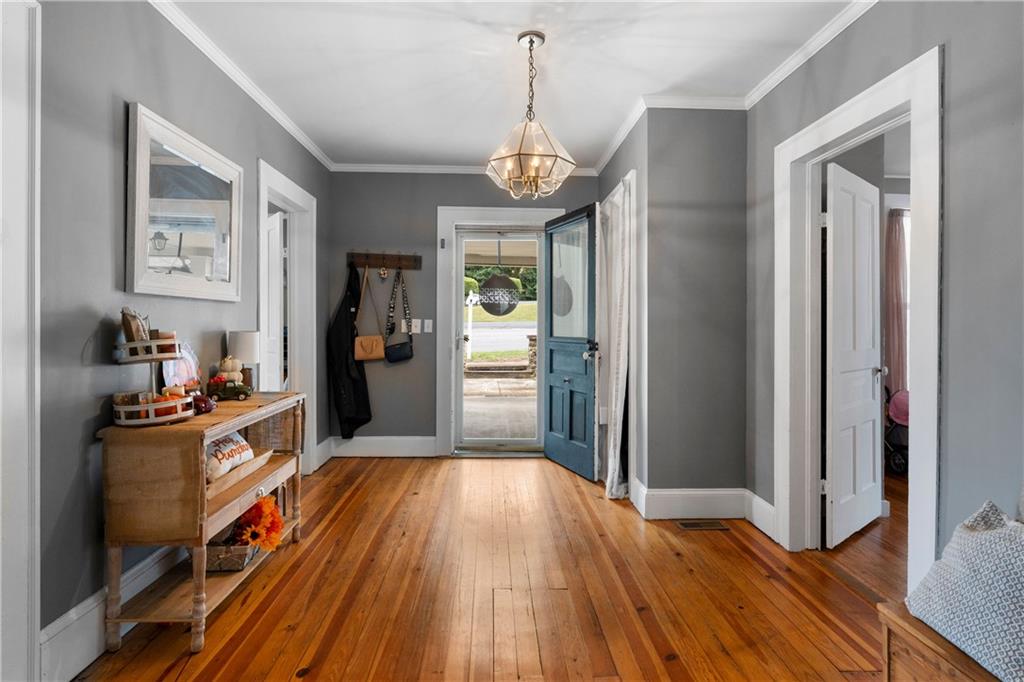 712 College Street Calhoun, GA 30701 - Photo 7 of 31 a kitchen with wooden floors appliances and cabinets
