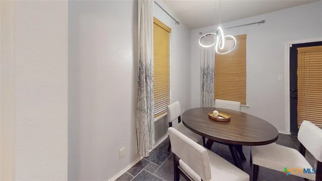 a view of a room that has a table and chairs