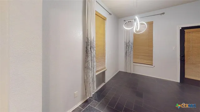 a view of a room with wooden floor and windows