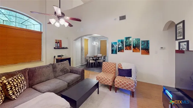 a living room with furniture and a chandelier