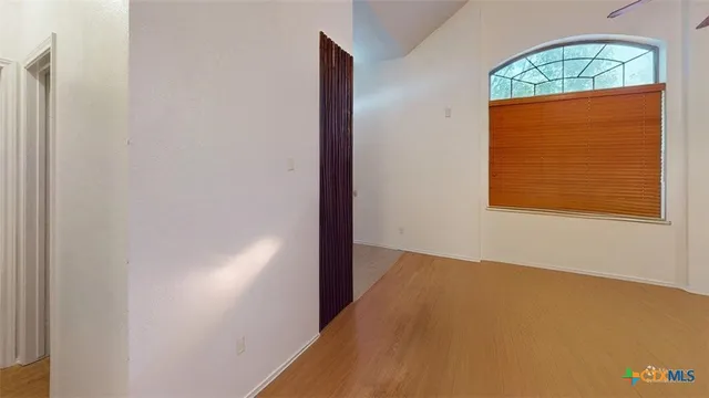 a view of an empty room with a window