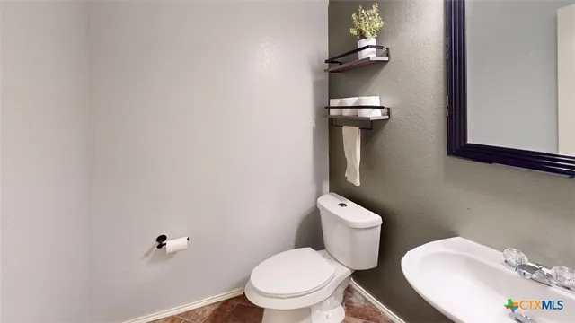 a white toilet sitting next to a bathroom sink