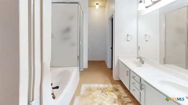 a bathroom with a double vanity sink and mirror