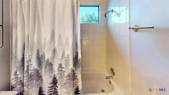 a bathroom with a bathtub and shower