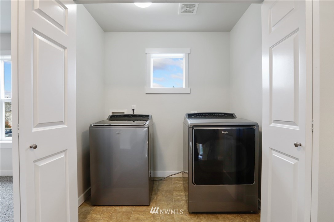 20329 Corbridge Road Southeast Monroe, WA 98272 - Photo 29 of 38 a utility room with wooden floor washer and dryer