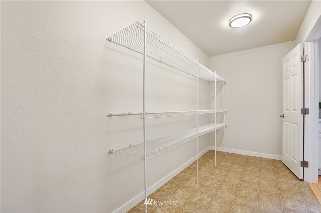 20329 Corbridge Road Southeast Monroe, WA 98272 - Photo 10 of 38 a view of an empty walk in closet with empty racks