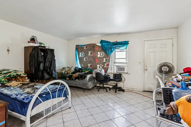 a bedroom with furniture and a gym equipment