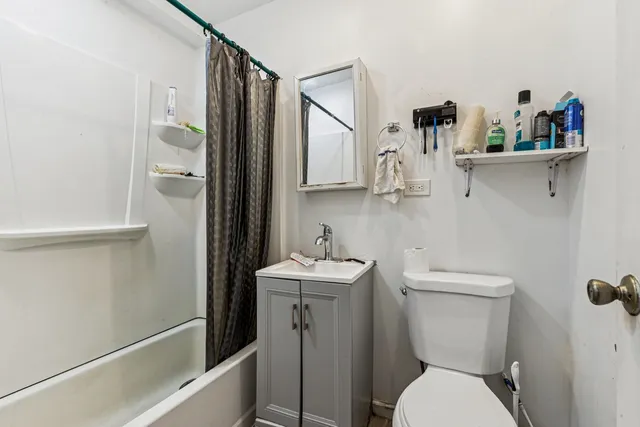 a white toilet sitting next to a bathroom sink