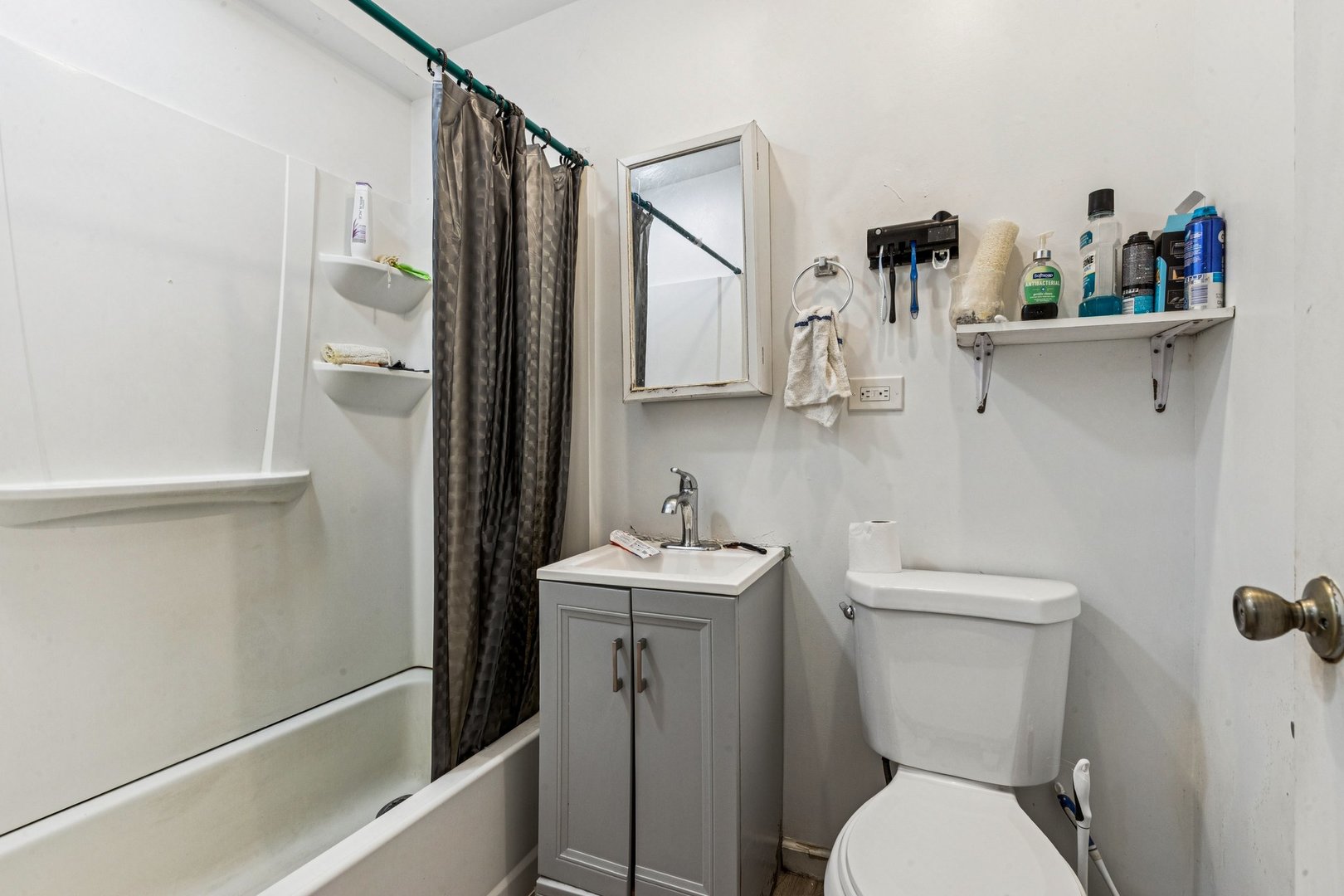 1115 East Algonquin Road, Unit 8 Arlington Heights, IL 60005 - Photo 7 of 11 a white toilet sitting next to a bathroom sink