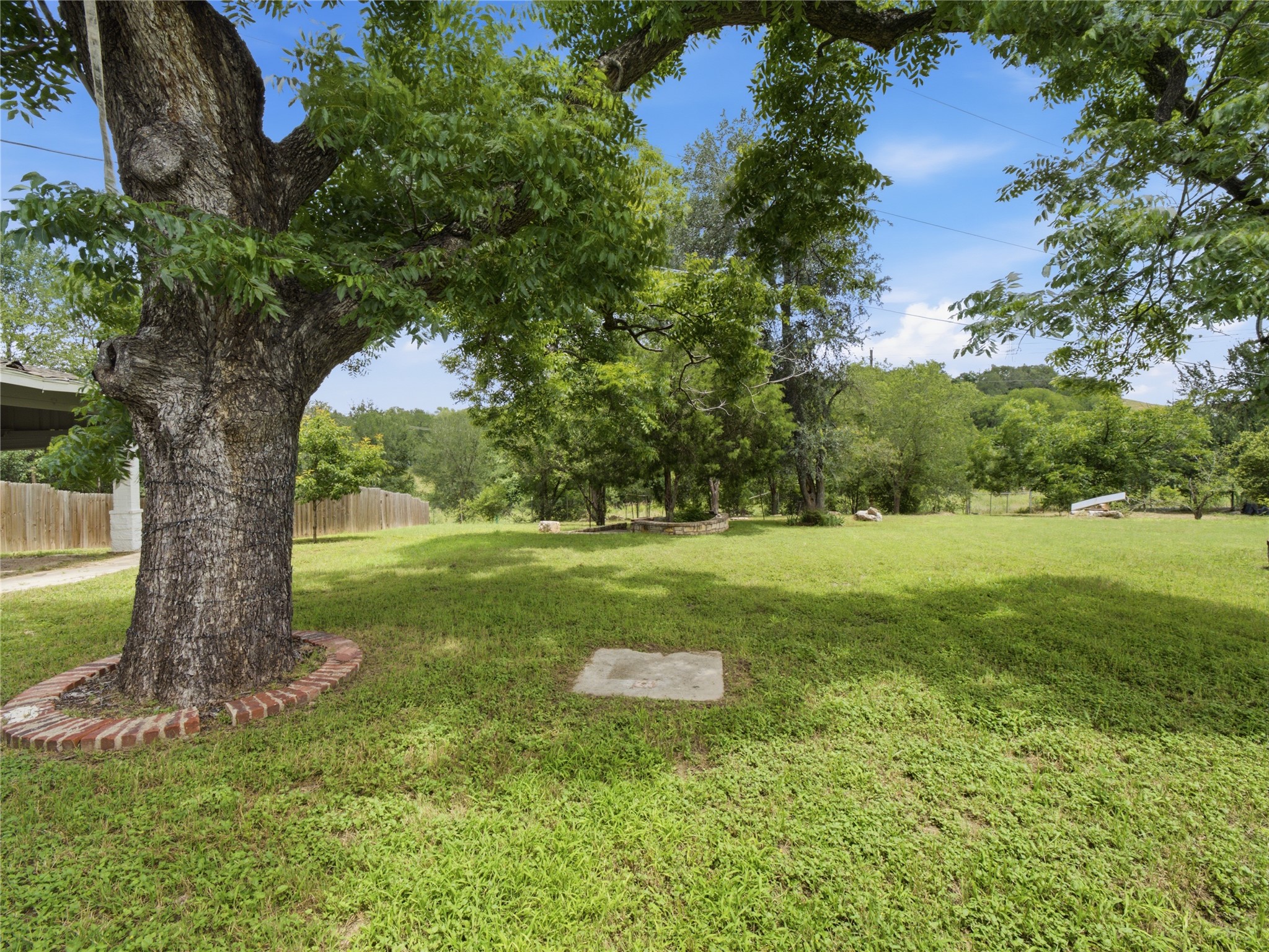 1108 Jolena Circle Austin, TX 78721 - Photo 20 of 21 A spacious backyard with mature trees provides abundant natural shade.