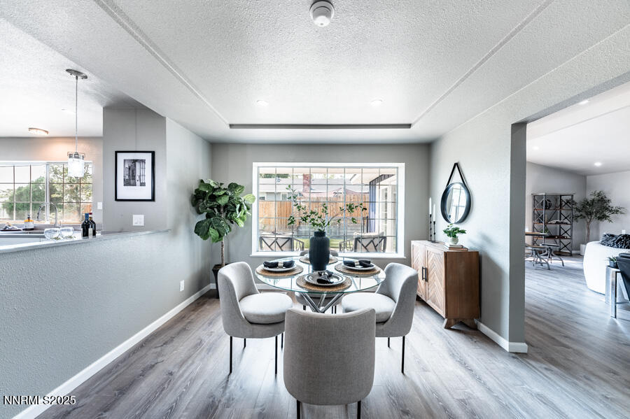 3390 Cashill Boulevard Reno, NV 89509 - Photo 13 of 51 a view of a dining room with furniture window and wooden floor