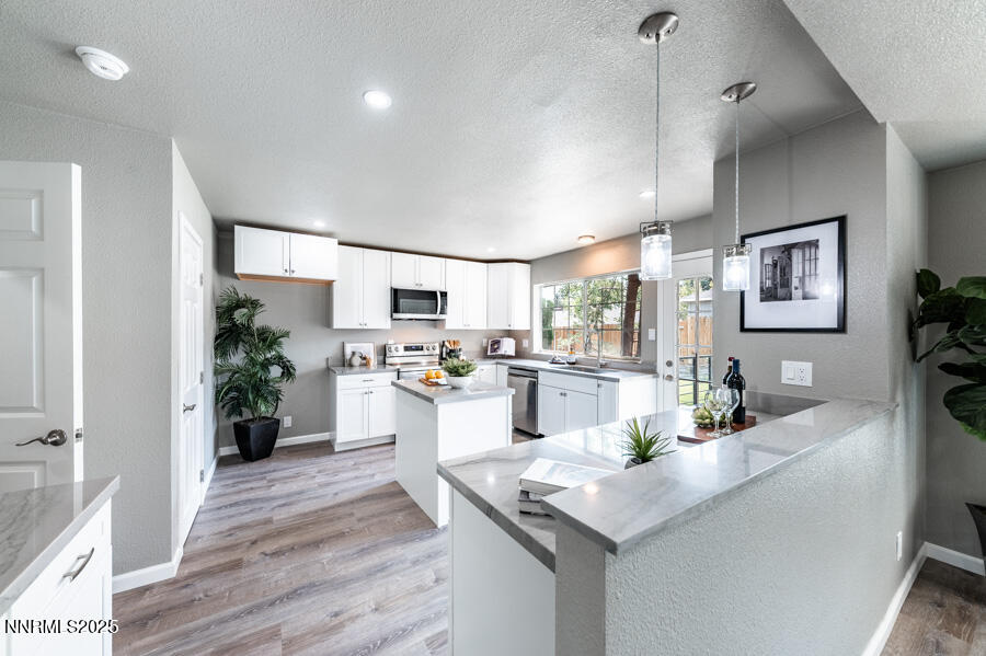 3390 Cashill Boulevard Reno, NV 89509 - Photo 16 of 51 a kitchen with white cabinets and refrigerator