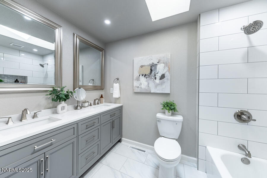 3390 Cashill Boulevard Reno, NV 89509 - Photo 35 of 51 a bathroom with a toilet sink and mirror