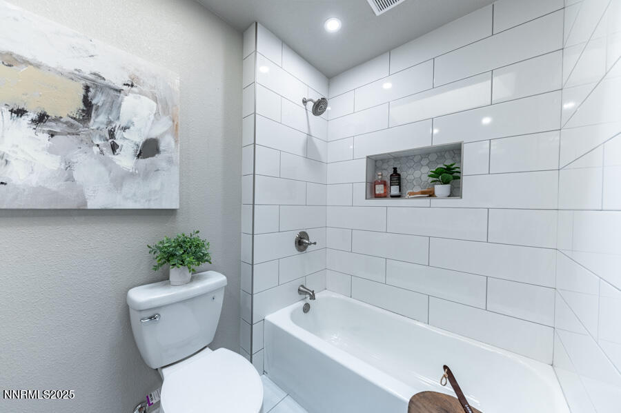 3390 Cashill Boulevard Reno, NV 89509 - Photo 36 of 51 a white toilet sitting next to a bath tub