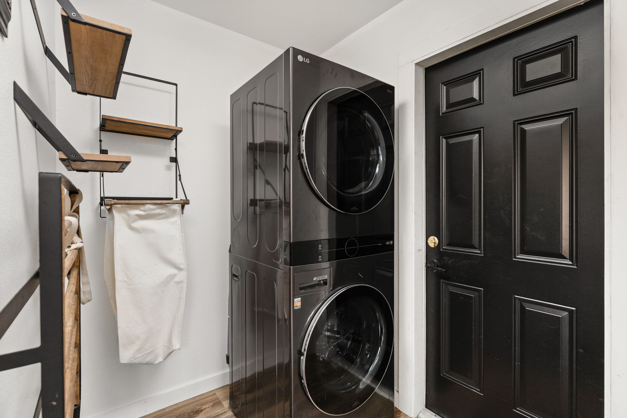 612 Meadowbrook Drive Georgetown, TX 78628 - Photo 17 of 35 Laundry area featuring stacked washer and clothes dryer and light wood finished floors