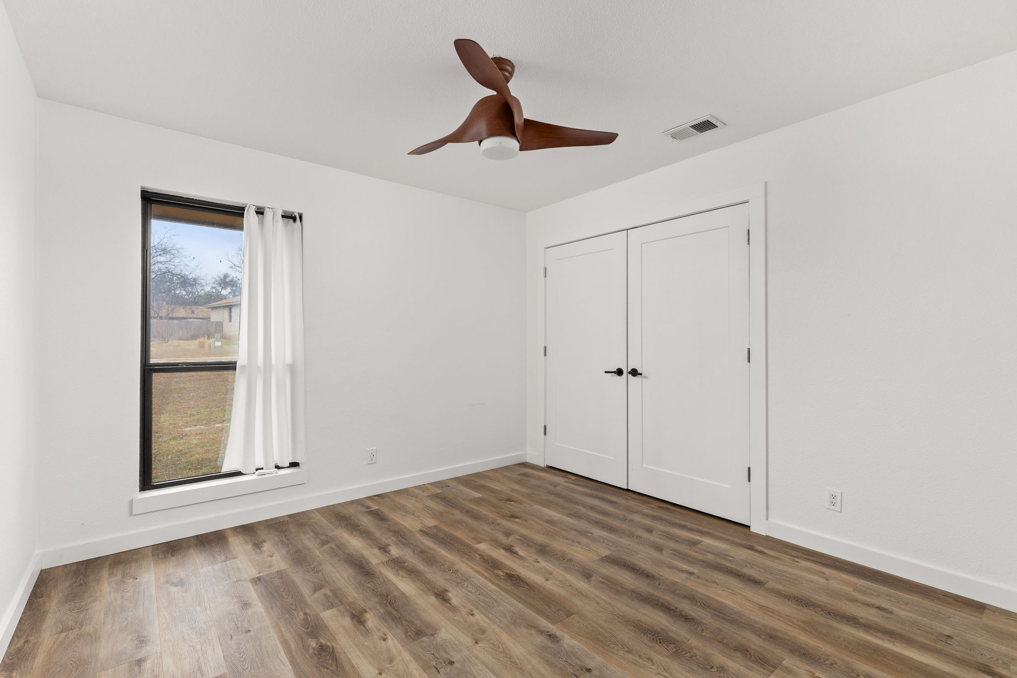 612 Meadowbrook Drive Georgetown, TX 78628 - Photo 26 of 35 Unfurnished bedroom featuring a closet, wood finished floors, and ceiling fan
