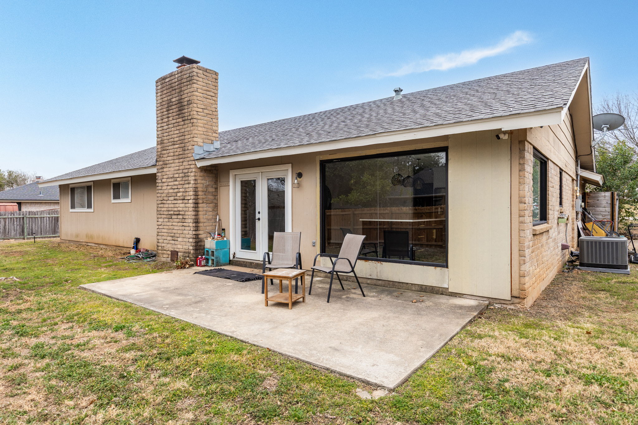 612 Meadowbrook Drive Georgetown, TX 78628 - Photo 29 of 35 Rear view of property with french doors, a shingled roof, a chimney, and a patio area