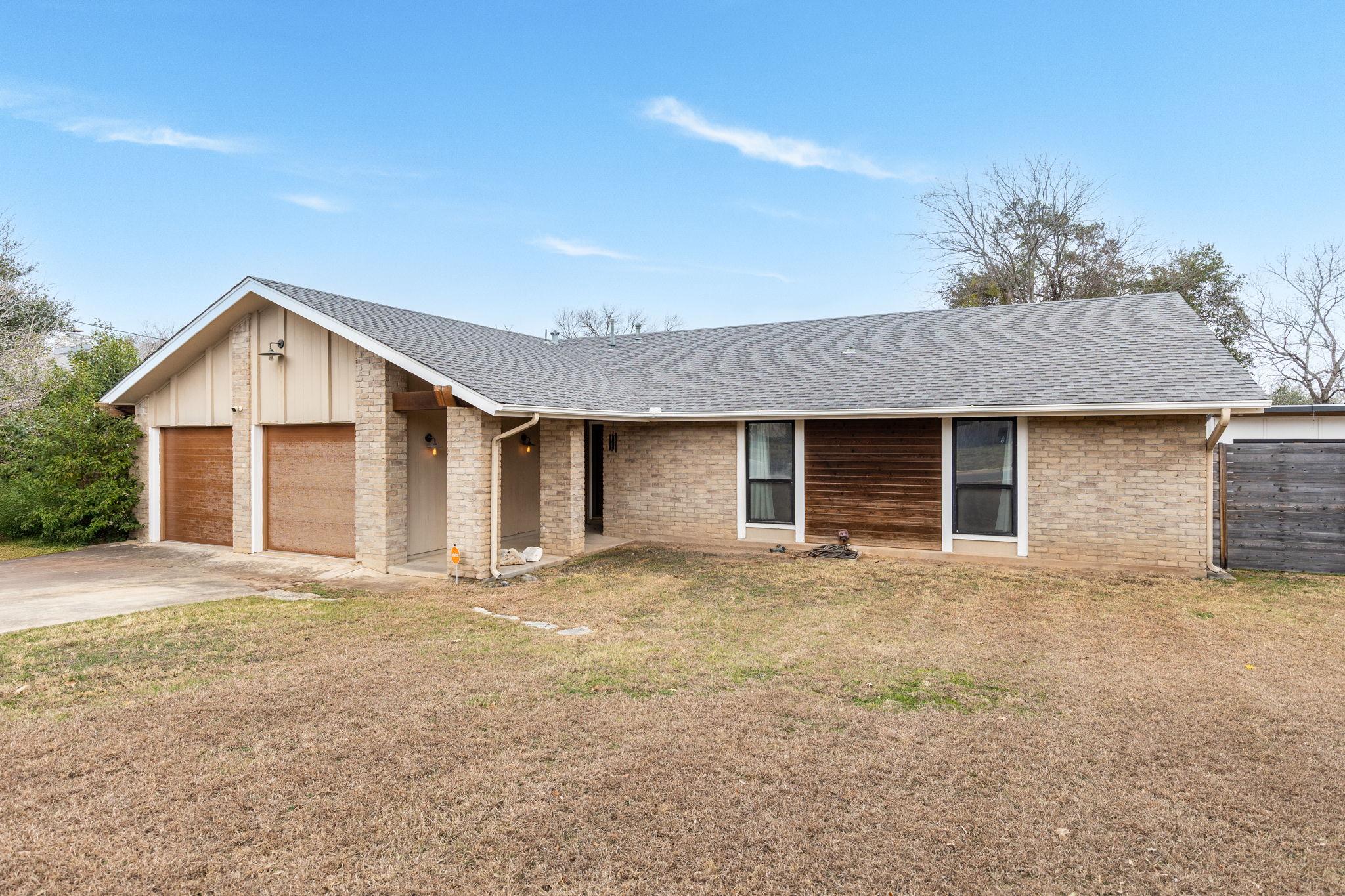 612 Meadowbrook Drive Georgetown, TX 78628 - Photo 3 of 35 Single story home with a shingled roof, a front yard, an attached garage, concrete driveway, and brick siding